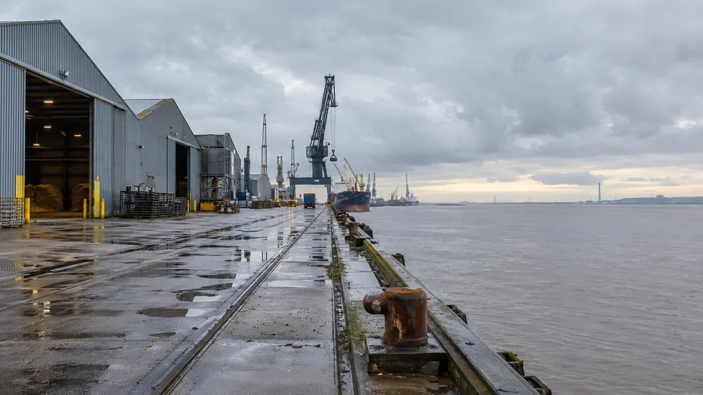 Industrial dockside warehouses beside an estuary